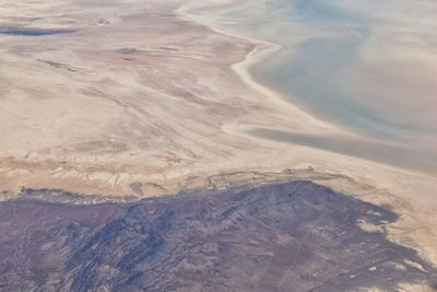 Aerial view from airplane of the great salt lake in rocky mountain range in utah, united states.