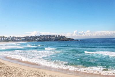 Scenic view of beach against blue sky