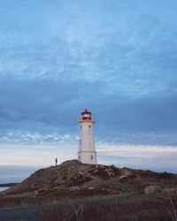 Lighthouse against sky during sunset