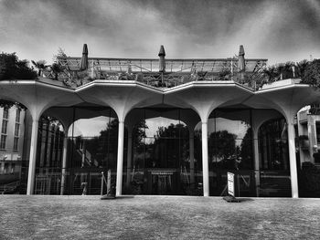 Arch bridge against sky in city