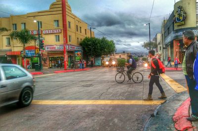 Man cycling on road in city