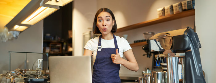 Portrait of young woman using mobile phone