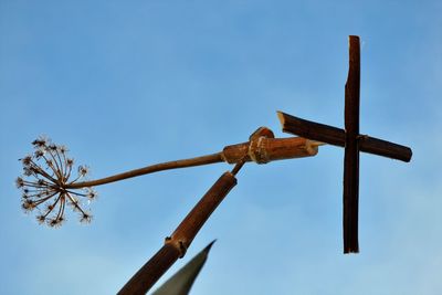 Low angle view of cross against blue sky