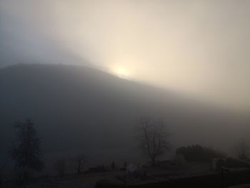 Scenic view of landscape against sky at morning