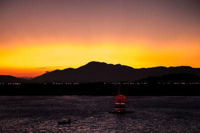 Scenic view of silhouette mountains against sky during sunset