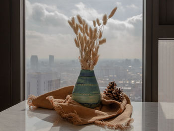 Close-up of cake on table against window at home