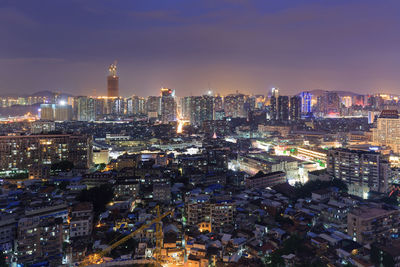 High angle view of city lit up at night