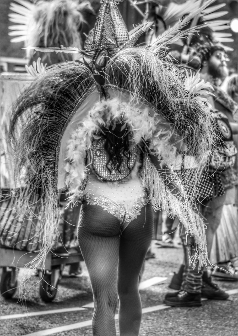 FULL LENGTH REAR VIEW OF WOMAN STANDING ON STREET