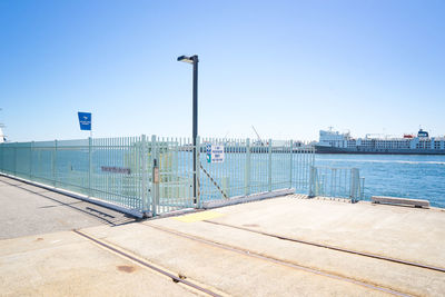 Street by swimming pool against clear blue sky