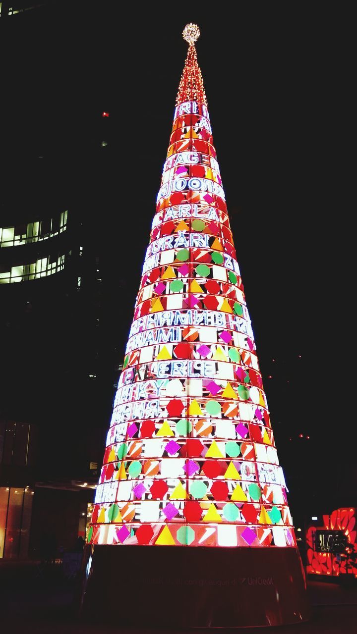 night, low angle view, illuminated, architecture, built structure, building exterior, red, sky, no people, tower, multi colored, outdoors, tall - high, city, clear sky, pattern, blue, famous place, architectural feature, modern