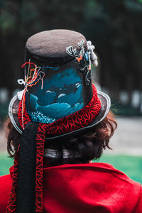 Rear view of man wearing decorated top hat