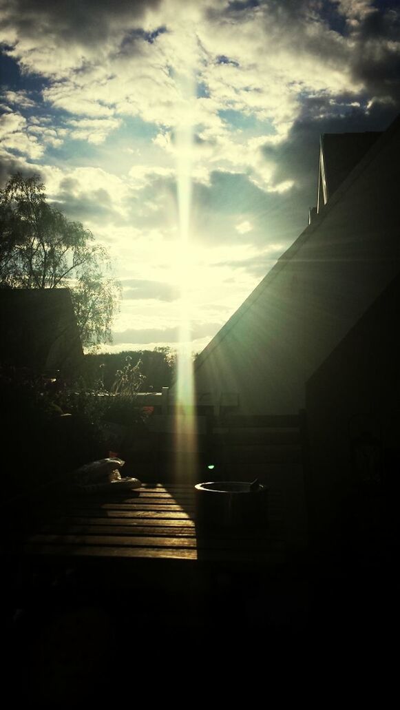 sunbeam, sun, sunlight, architecture, building exterior, built structure, lens flare, sky, transportation, car, land vehicle, silhouette, street, mode of transport, city, sunny, cloud - sky, road, tree, the way forward