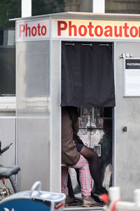 Low section of people sitting at photo booth