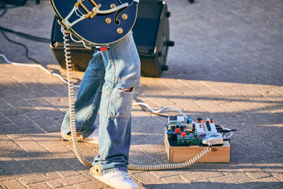 Guitar pedalboard effects pedal box for electric guitar on floor at outdoor rock party