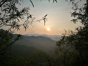 Scenic view of silhouette mountains against sky at sunset