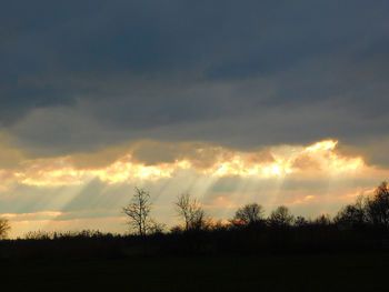 Silhouette of landscape against cloudy sky