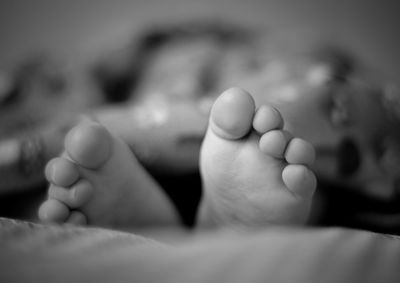 Close-up of baby sleeping on bed