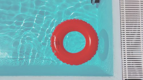 High angle view of red floating on swimming pool