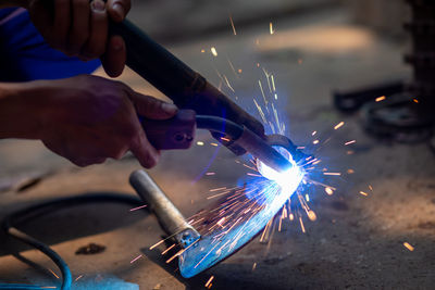 Midsection of person working with fire crackers