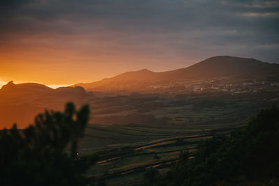 Scenic view of mountains against sky during sunset