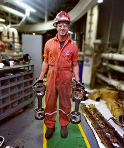 Portrait of man standing in factory