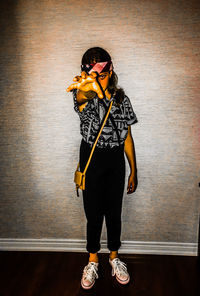 Young girl in stranger things halloween costume against wall 