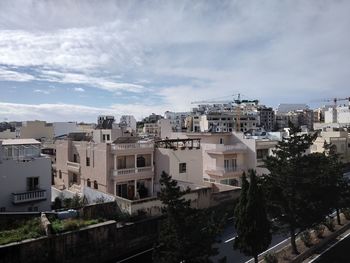 High angle view of buildings in city against sky