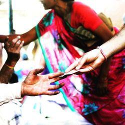 Close-up of hands holding multi colored people