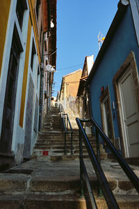 Low angle view of steps amidst buildings in town