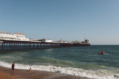 Brighton palace pier in sea against clear sky