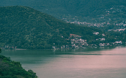 Scenic view of river by tree mountains