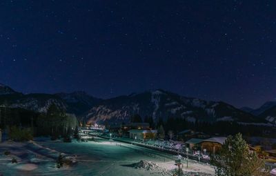 Scenic view of illuminated mountains against sky at night