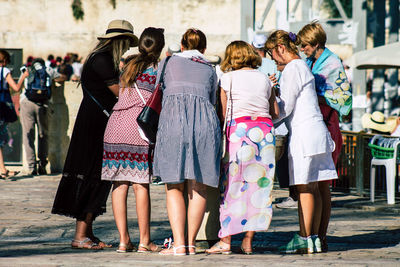 Rear view of people against the wall