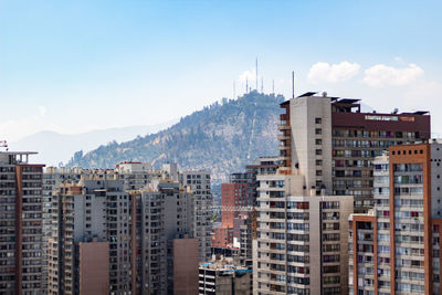 Buildings in city against sky