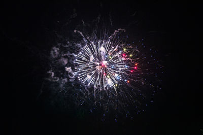Low angle view of firework display at night