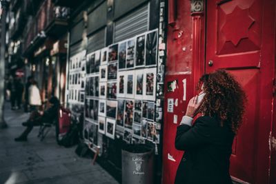 Woman standing in front of red building