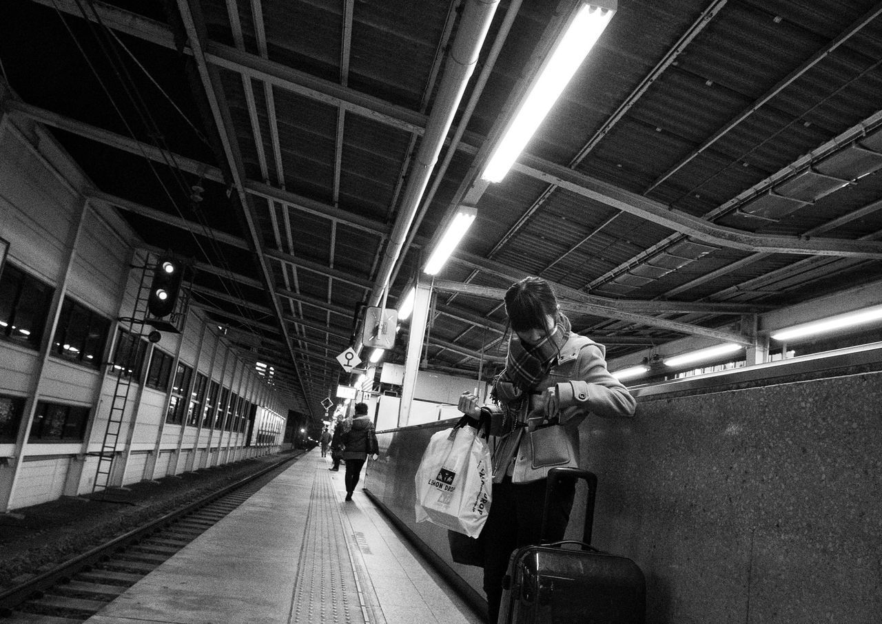 men, indoors, walking, lifestyles, illuminated, architecture, built structure, full length, the way forward, person, ceiling, transportation, leisure activity, lighting equipment, rear view, diminishing perspective, group of people