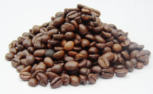 Close-up of coffee beans against white background