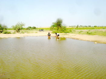 Two people sitting in lake