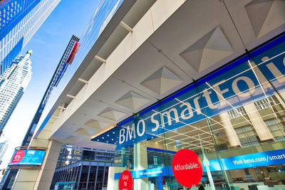 Low angle view of illuminated building against blue sky