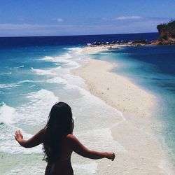 Rear view of sensuous woman at beach