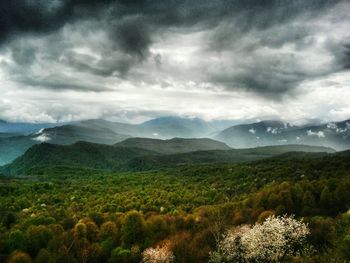 Scenic view of mountains against cloudy sky