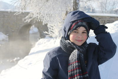 Portrait of smiling teenage boy wearing warm clothing during winter