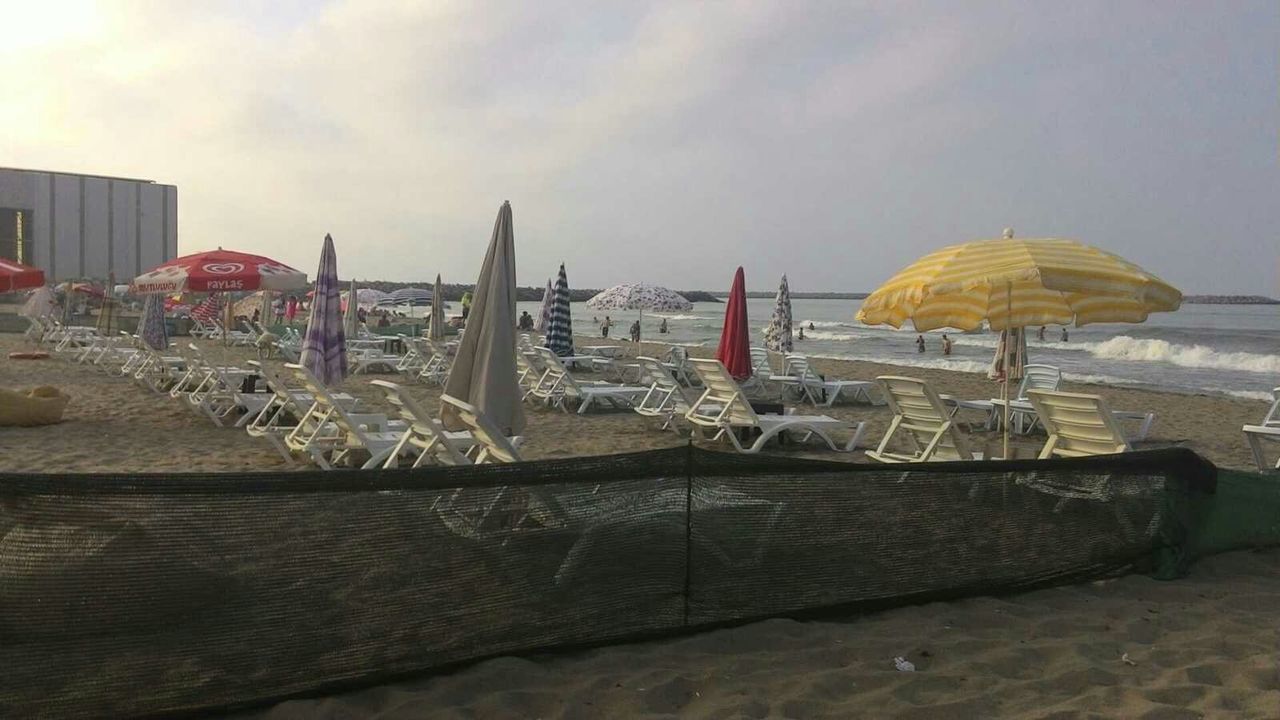 beach, sea, water, sky, built structure, architecture, sand, building exterior, shore, chair, day, absence, outdoors, nature, nautical vessel, cloud - sky, sunlight, incidental people, table, moored