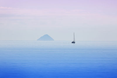 Sailboat in sea against sky