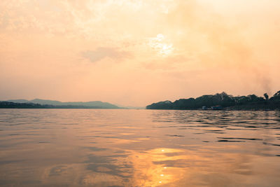 Scenic view of sea and mountains during sunset