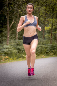 Smiling woman running on road