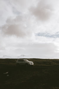 Airplane on field against sky