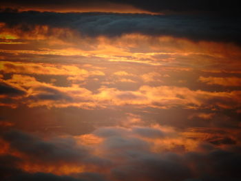 Low angle view of cloudy sky at sunset