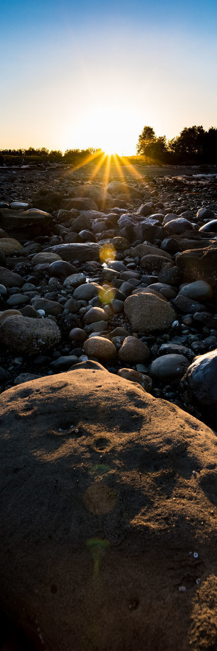 SURFACE LEVEL OF ROCKS AT SUNSET